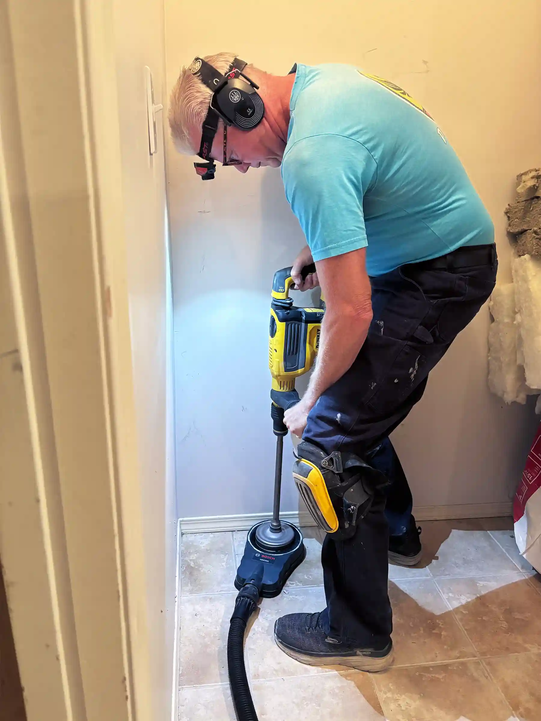 Greg Wheaton drilling the radon well to aide in mitigation system.