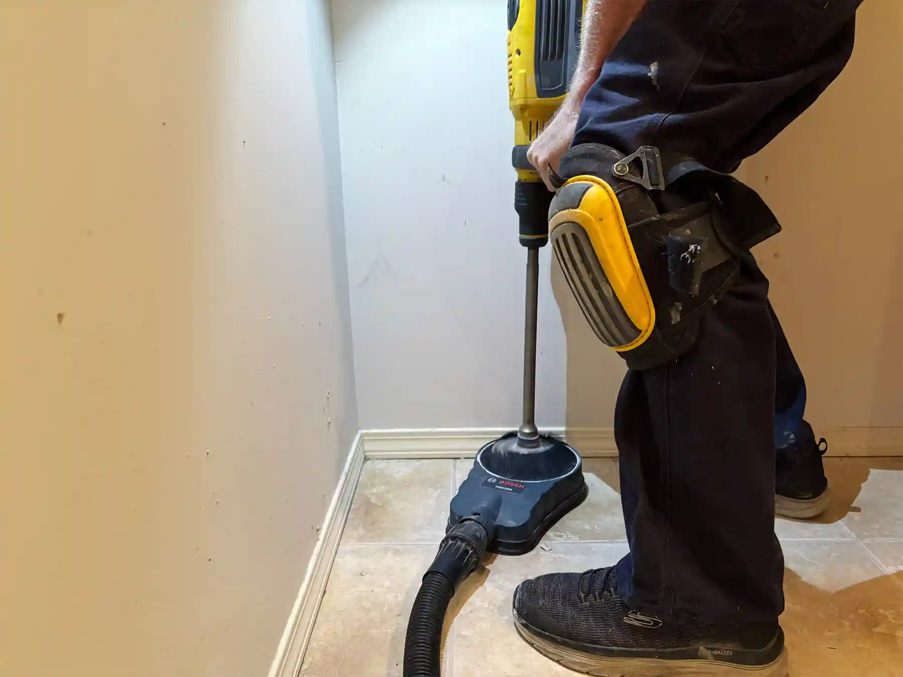 Greg Wheaton drilling the radon well to aide in mitigation system.