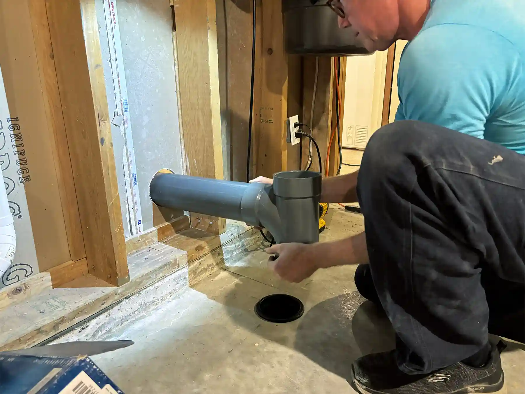 Radon specialist Greg Wheaton installing a mitigation system.